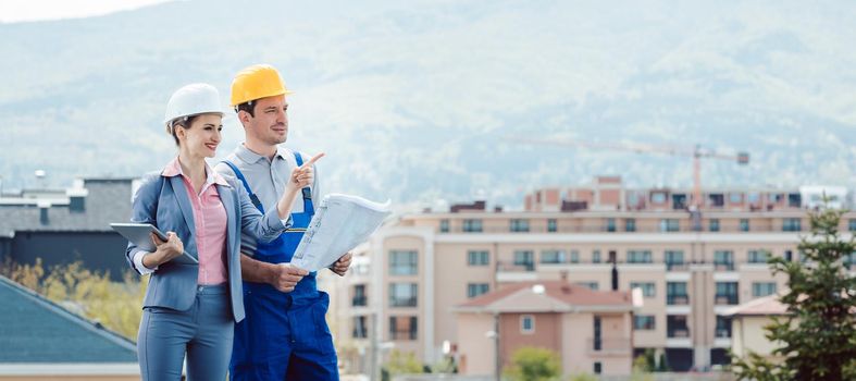 Property developer and construction worker creating project together envisaging the future