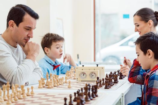 People in chess school learning the game