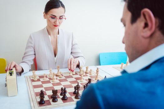 Business people playing chess, concept picture