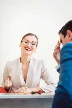 Excited businesswoman winning in chess due to better strategy