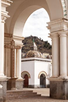 View through archway onto a small chapel on the courtyard of the Basilica of Our Lady of Copacabana in the small tourist town of Copacabana along Lake Titicaca in Bolivia