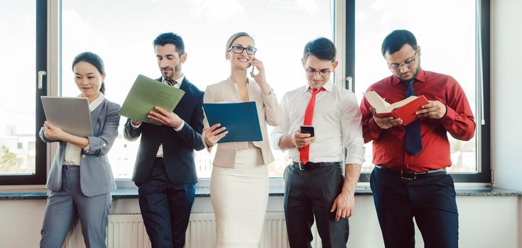 Diversity team of business people working in the office on different tasks