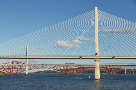 The new Queensferry Crossing bridge over the Firth of Forth with the older Forth Road bridge and the iconic Forth Rail Bridge in Edinburgh Scotland
