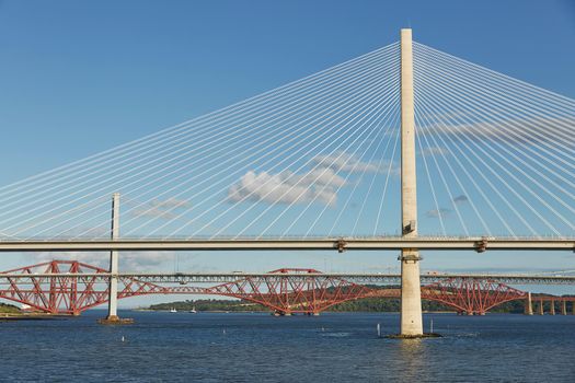 The new Queensferry Crossing bridge over the Firth of Forth with the older Forth Road bridge and the iconic Forth Rail Bridge in Edinburgh Scotland