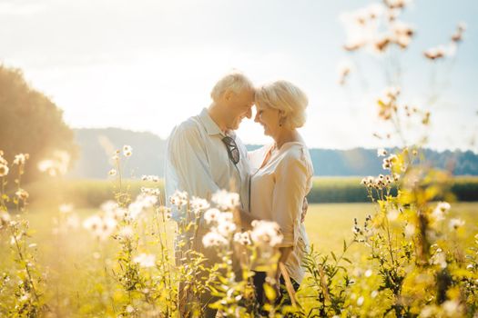 Senior woman and man hugging still being in love in a romantic setting