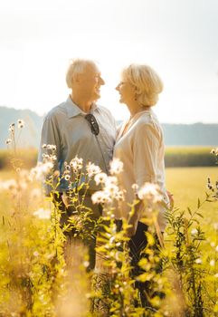 Senior woman and man hugging still being in love in a romantic setting