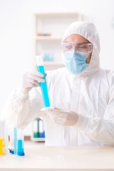 Young chemist student working in lab on chemicals