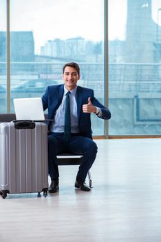 Businessman waiting at the airport for his plane in business class