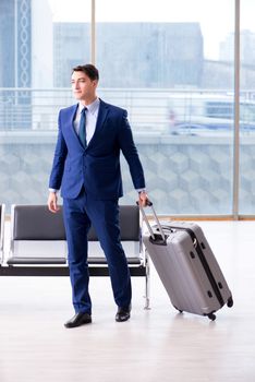 Businessman waiting at the airport for his plane in business class