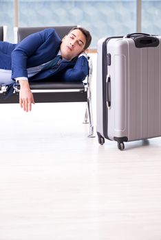Businessman waiting at the airport for his plane in business class
