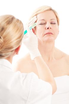 Botox - Age and beauty; a doctor is doing the injection