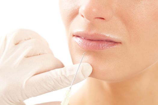 Botox - Age and beauty; a doctor is doing the injection