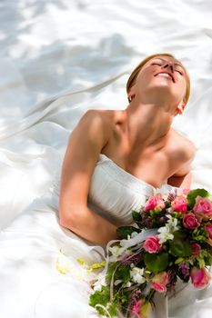 Bride sitting holding a bouquet of flowers in her hand