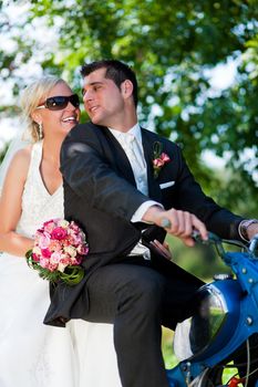 Wedding couple on a motor bike riding in the future