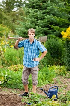 gardener digging the soil in spring with a spade to make the garden ready