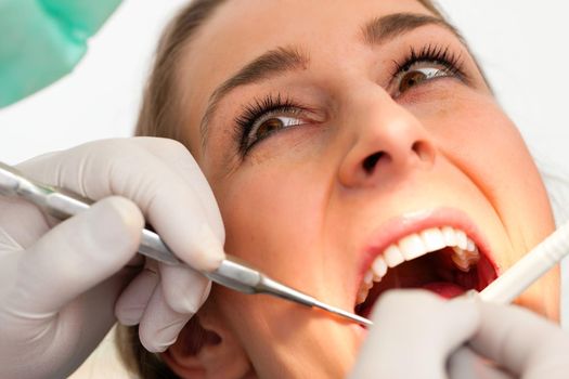 Female patient with dentist in the course of a dental treatment