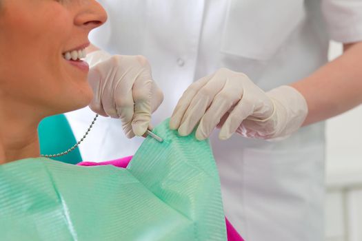 Patient at the beginning of a treatment - Assistant is putting the protection on