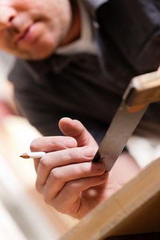 Carpenter working with angle and pencil in his workshop