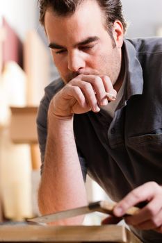 Carpenter working with angle and pencil in his workshop