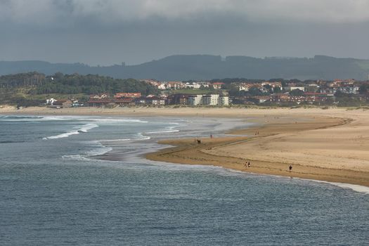 People enjoying a summer day on a beach in Santander, Spain.