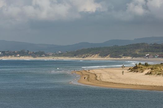 People enjoying a summer day on a beach in Santander, Spain.