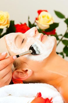 Woman having a mask or cream applied in the course of a beauty or wellness treatment