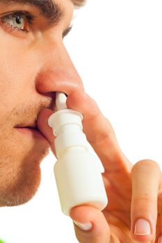 Young man is sick with nasal spray - close-up