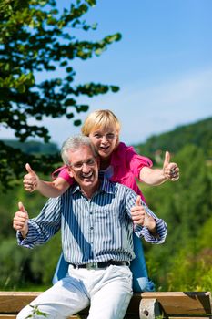 happy mature or senior couple having walk