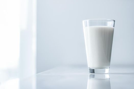 Dairy, healthy nutrition and breakfast concept - World Milk Day, full glass on marble table