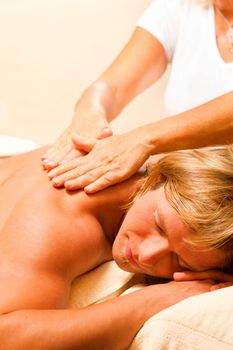 Man in wellness and spa setting having a massage