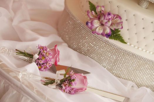 White wedding cake decorated with flowers and set of cutters