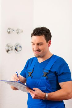 Technician reading the water meter to check consumption