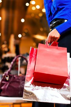 woman in a shopping mall with colorful bags