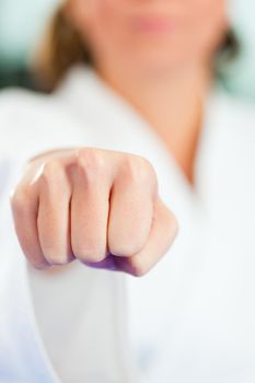 Young woman in martial art training in a gym