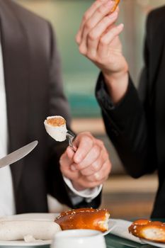 Male and female executive eating delicious food together