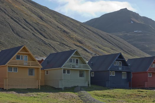 Traditional colorful wooden houses on a sunny day in Longyearbyen Svalbard.
