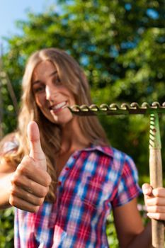 Gardening in summer - happy woman grate working