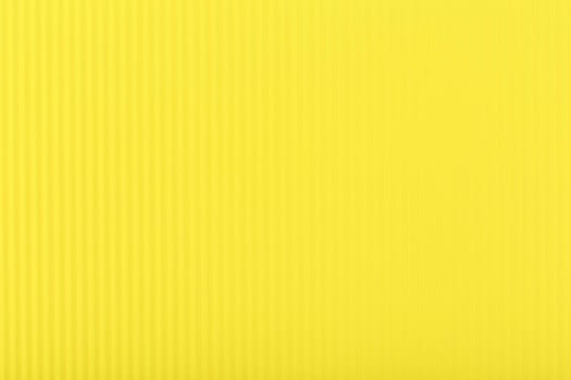 Yellow texture with stripes. Bright yellow background with copy space. Frilled yellow piece of paper. Template concept
