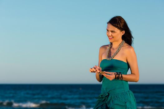 Women looking for sea shells in romantic sunset