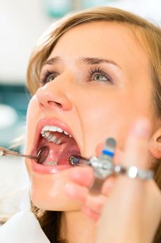 dentist holding a syringe and anesthetizing his patient