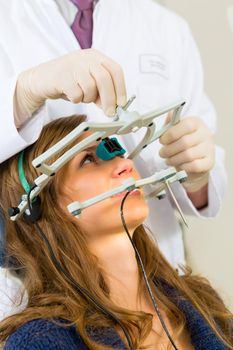 Female patient with dentist in a dental treatment, wearing gloves