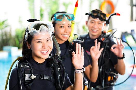 Asian people at the diver Course on holiday in wetsuit with an oxygen tank