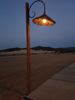 a lamp post on the beach avenue during a summer evening