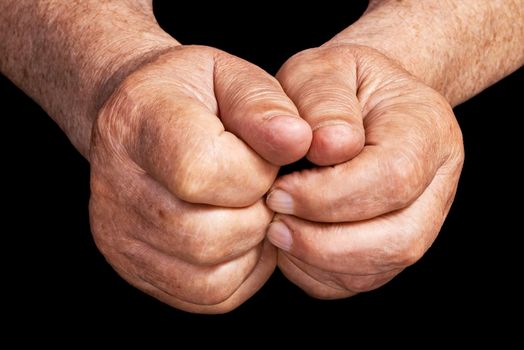 Senior hands on a black background