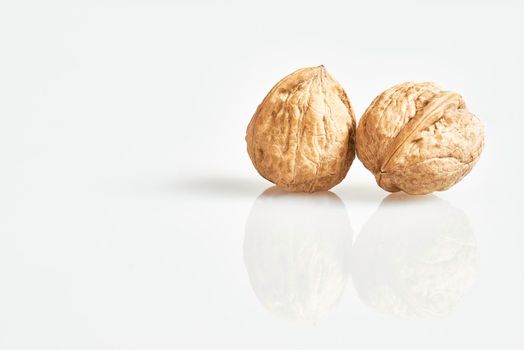 Two walnuts of reflection on clean background