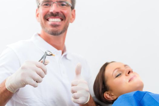 Female patient with dentist in a dental successful treatment