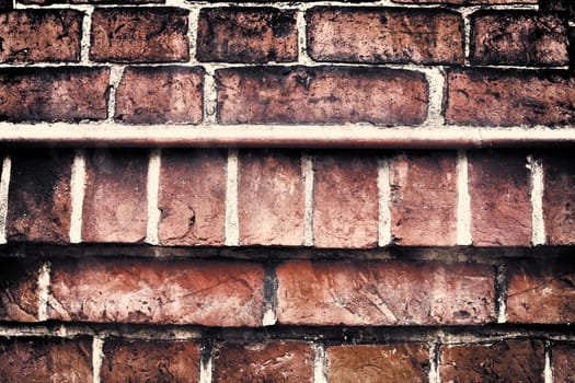 Aged and weathered old brick wall texture in a vintage retro design 