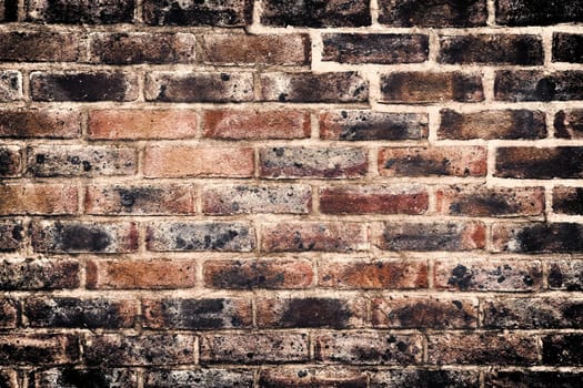 Aged and weathered old brick wall texture in a vintage retro design 