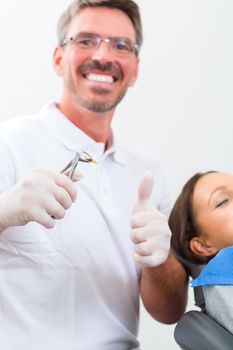 Female patient with dentist in a dental successful treatment