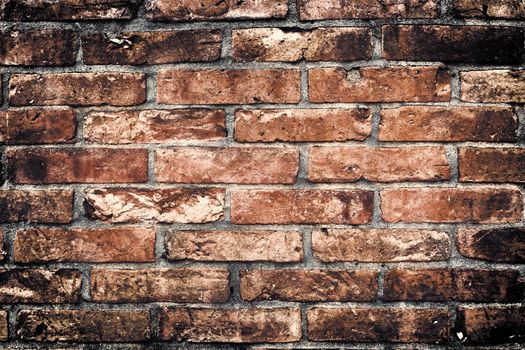 Aged and weathered old brick wall texture in a vintage retro design 